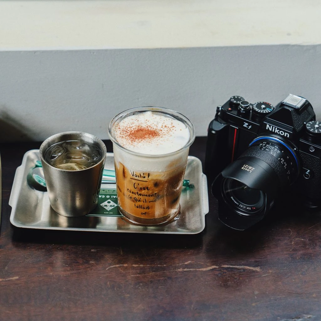 A vintage espresso machine sitting on a marble counter inside a small Damascus café, morning light